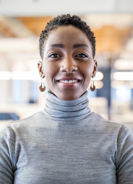 Woman entrepreneur smiles and looks into the camera