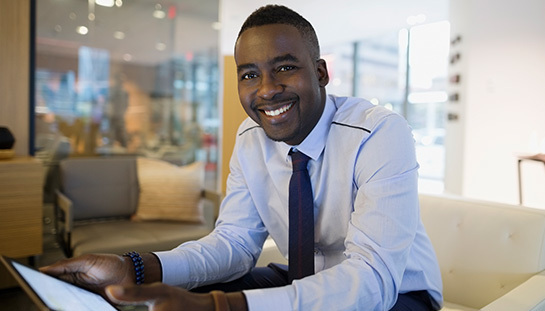 entrepreneur smiling, holding a tablet