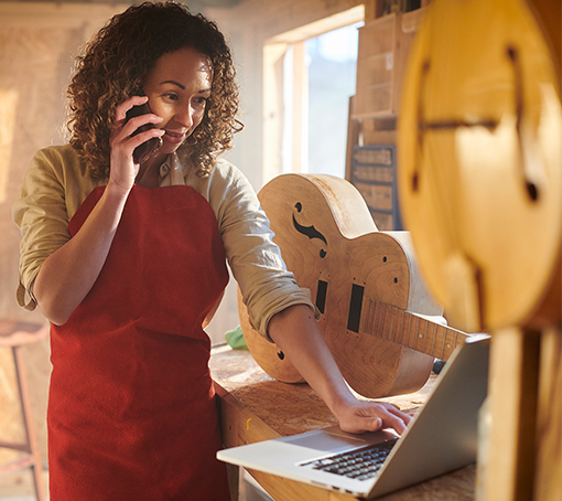 Entrepreneur in her workshop, talking on the phone