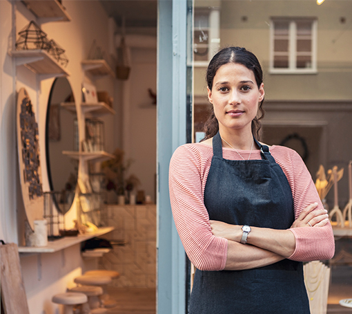 business owner standing in front of her store