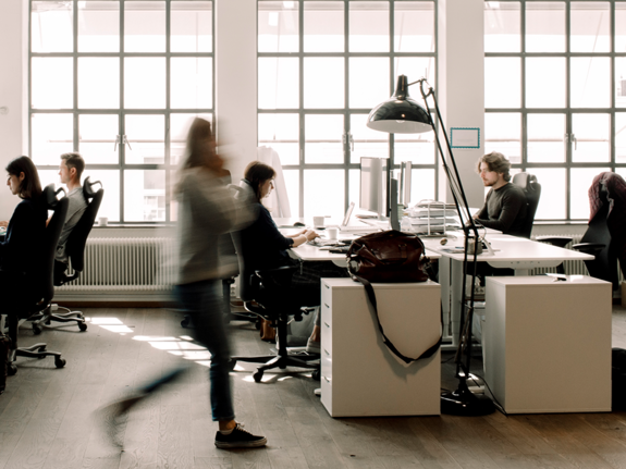  blur motion of a woman walking in an office