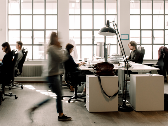 blur motion of a woman walking in an office