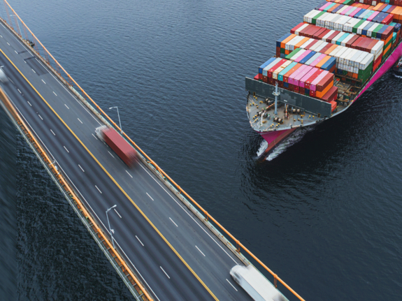 cargo ship navigating near a bridge