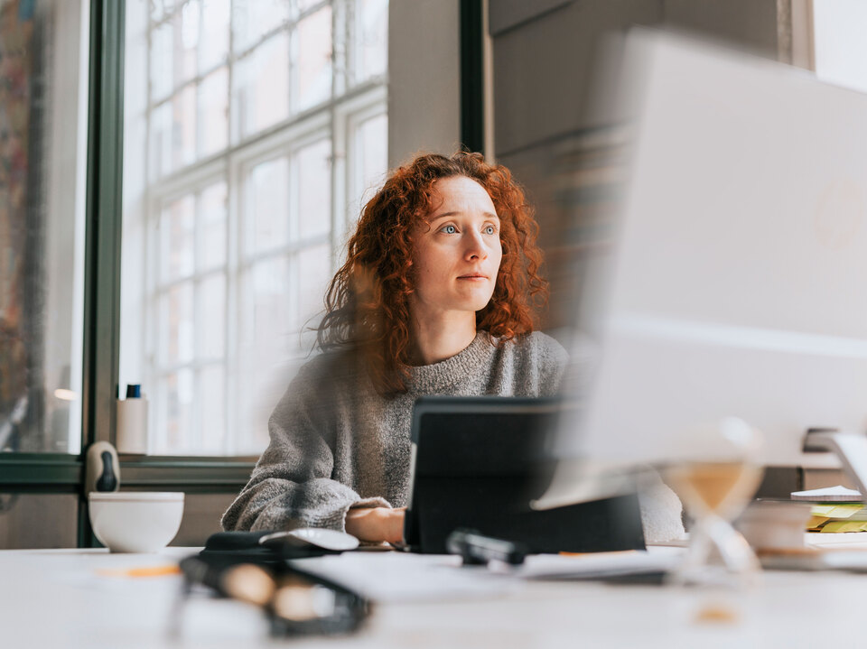 Red hair woman working on a computer